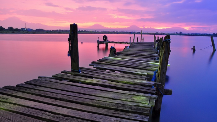 Wooden dock on a lake at sunset