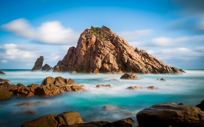 Rocky island in the sea with blue sky