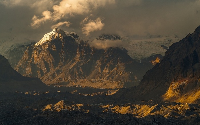 Sunlight on Snowy Mountain Peaks at Sunset