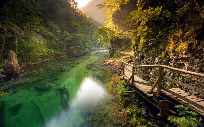 Wooden walkway along a turquoise river in Slovenia