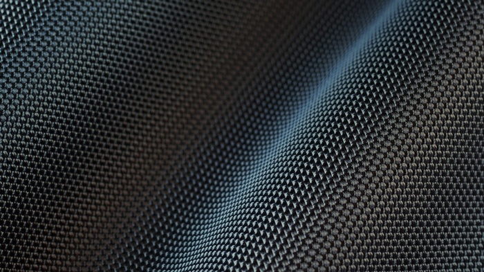 Close-up of a dark, wavy carbon fiber texture pattern