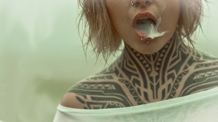 Teya Salat with tattoos and piercings smoking