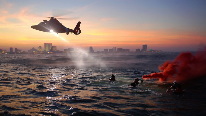 Coast Guard helicopter rescues people in the ocean