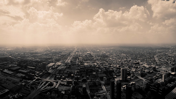 Aerial view of a sprawling city with clouds