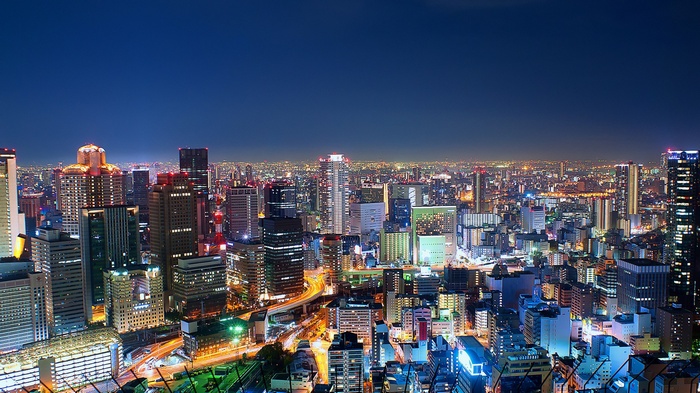 Osaka cityscape at night with illuminated skyscrapers