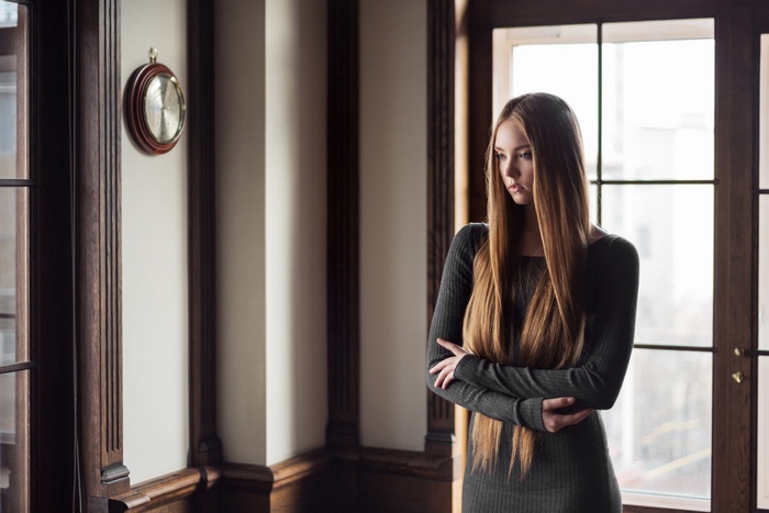 Woman with long brown hair looking away