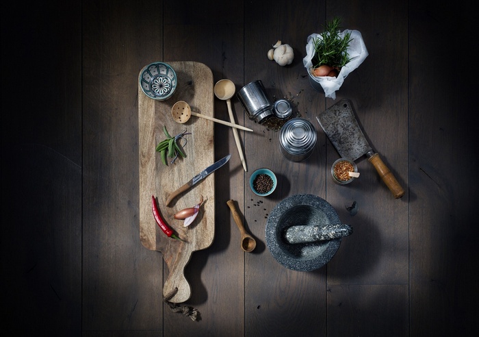 Kitchen utensils and ingredients on a wooden table