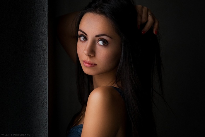 Portrait of a woman with hands in her hair