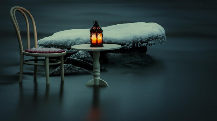 Chair and table with lantern in snowy water