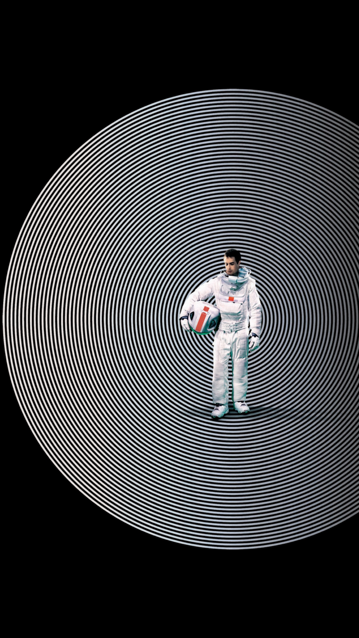 Astronaut Sam Rockwell holding a helmet with concentric circles