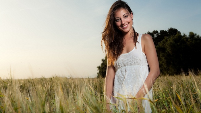 Lorena Garcia in a white dress in a field