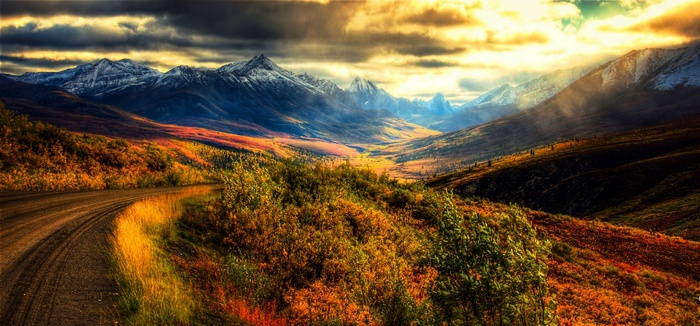 Autumn landscape with mountains and a dirt road