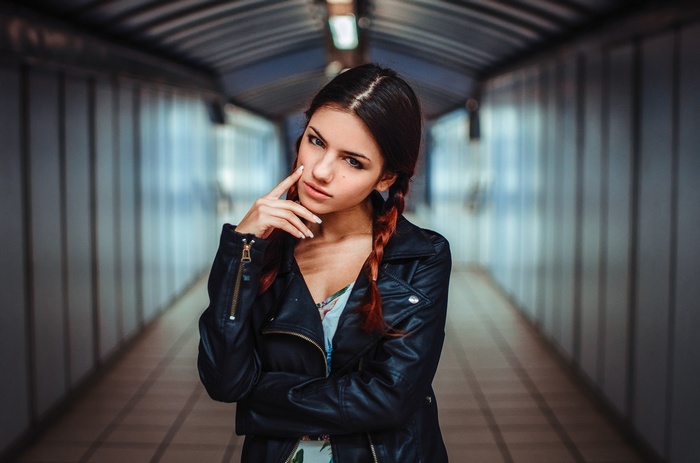 Woman with braids in a leather jacket
