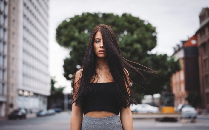 Julia Carina with hair in face in urban setting