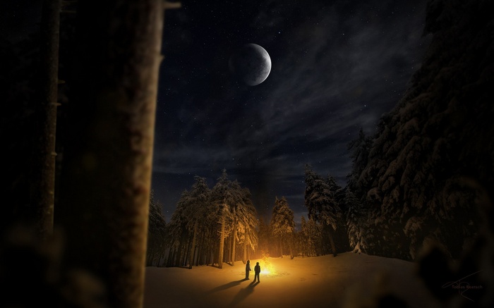 Couple by campfire under the moon in a snowy forest
