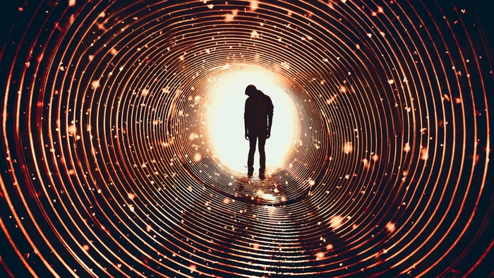 Silhouette of a man in a glowing tunnel
