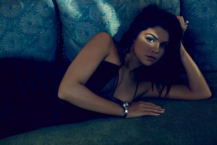 Selena Gomez lying on a couch