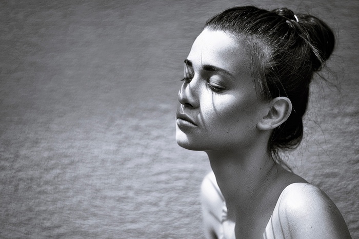 Monochrome portrait of a woman with shadows on her face