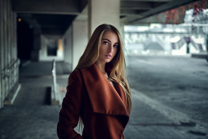 Woman in a brown coat standing outdoors
