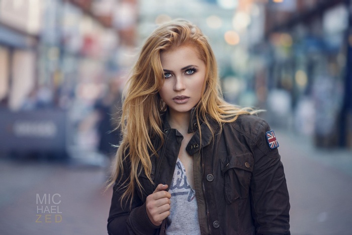 Woman with blonde hair and blue eyes in a jacket