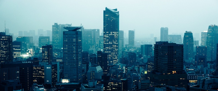Tokyo cityscape at dusk with illuminated skyscrapers