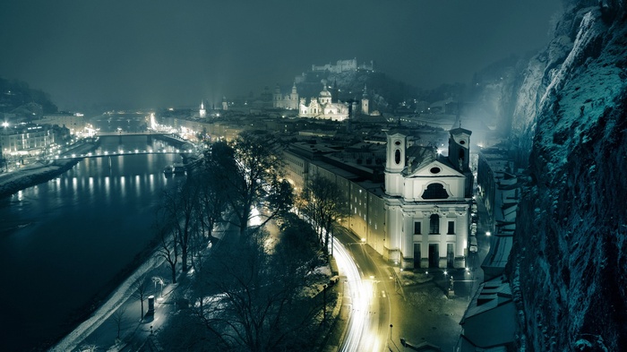 Salzburg at night with a river and castle
