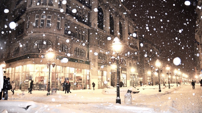 Snowy street in Sarajevo at night with street lamps