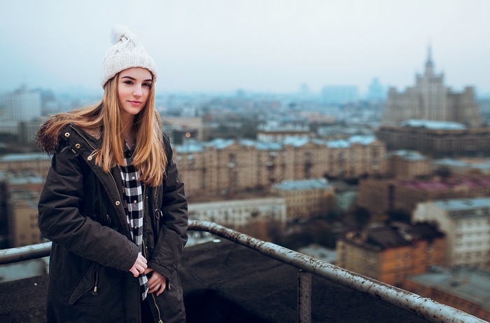 Maryana Ro on a balcony overlooking a city
