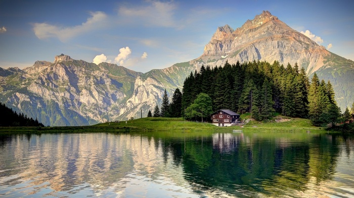 Lake and mountains with a house and forest