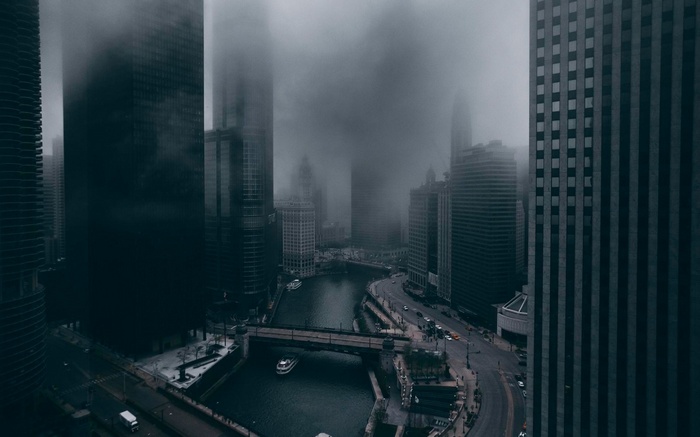 Chicago skyline shrouded in mist over a river