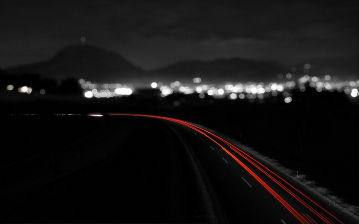 Long exposure of a road with city lights at night