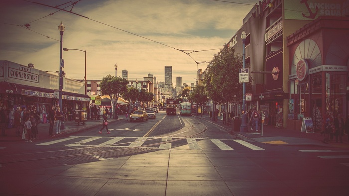 San Francisco street with cable cars and city skyline