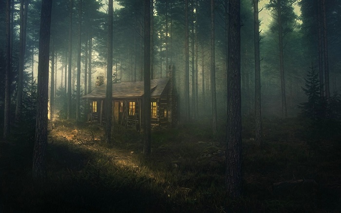 Log cabin in a misty forest at dusk