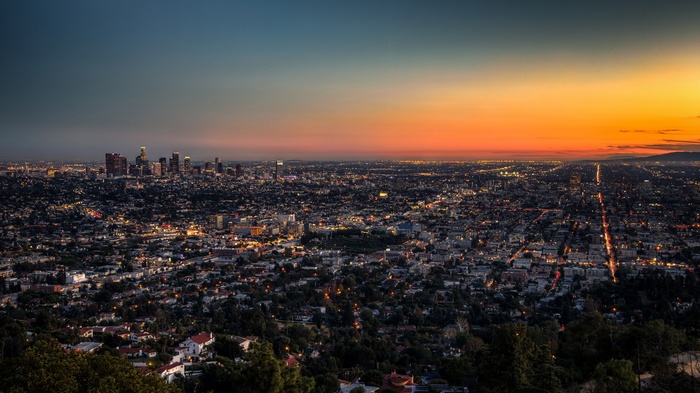 Los Angeles cityscape at dusk with a vibrant sunset