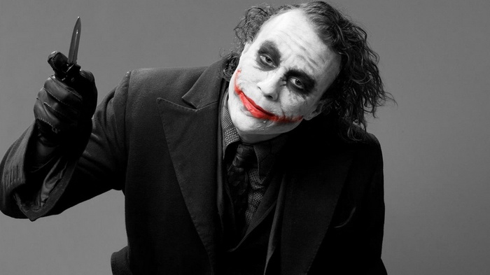 Heath Ledger as the Joker holding a knife