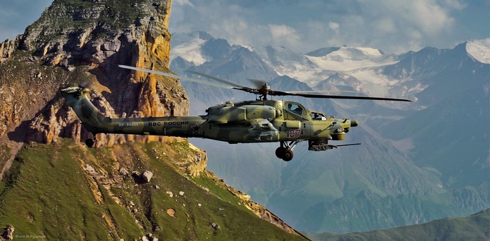 Mil Mi-28 helicopter flying over mountains