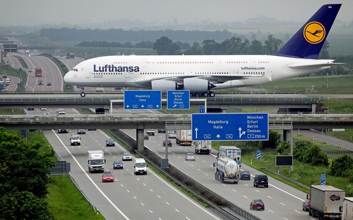 Lufthansa Airbus A380 flying over a highway in Germany