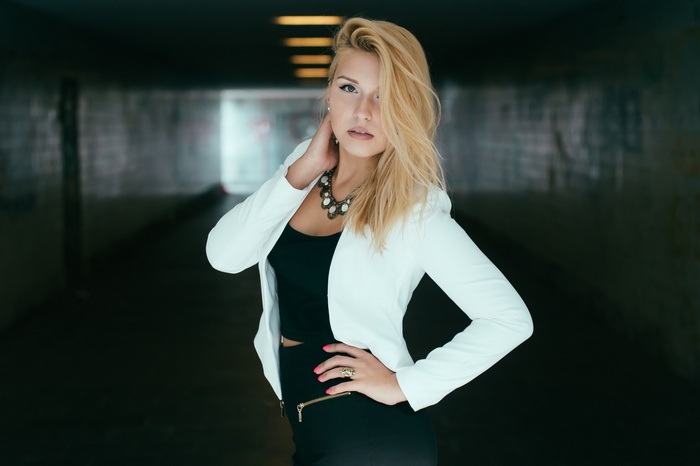 Woman in white blazer and black skirt