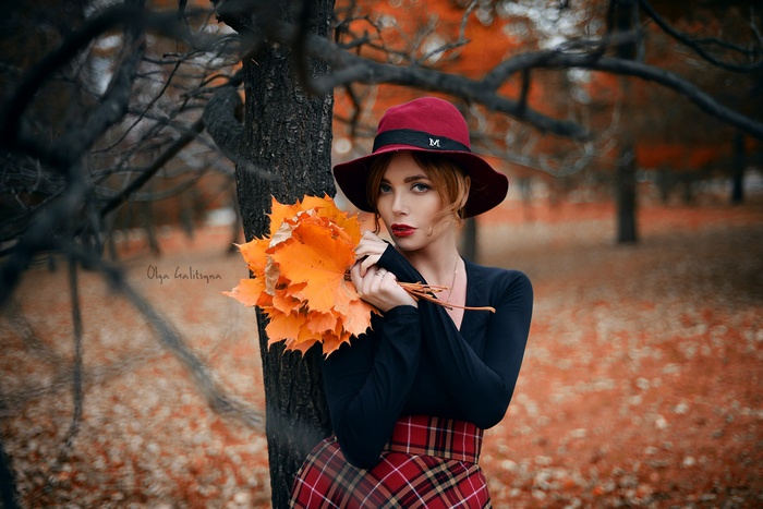 Olga Galitsyna in a red hat with autumn leaves