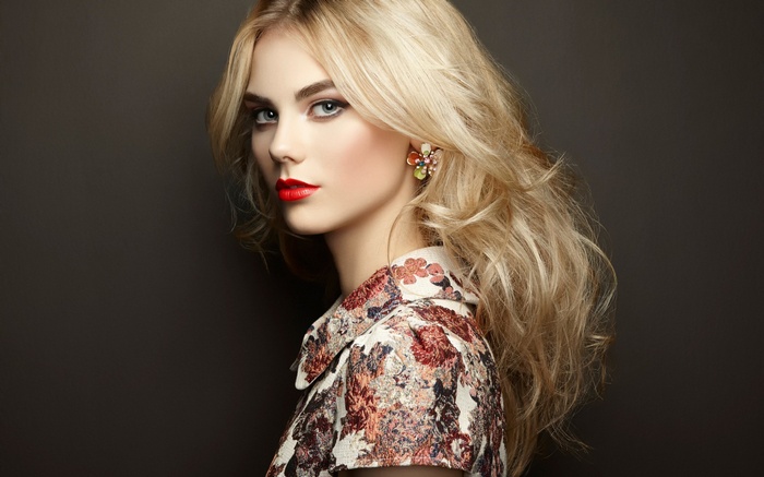 Blonde woman with red lipstick and floral shirt