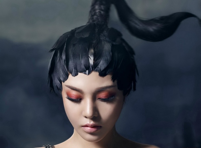 Asian woman with black swan feather headdress