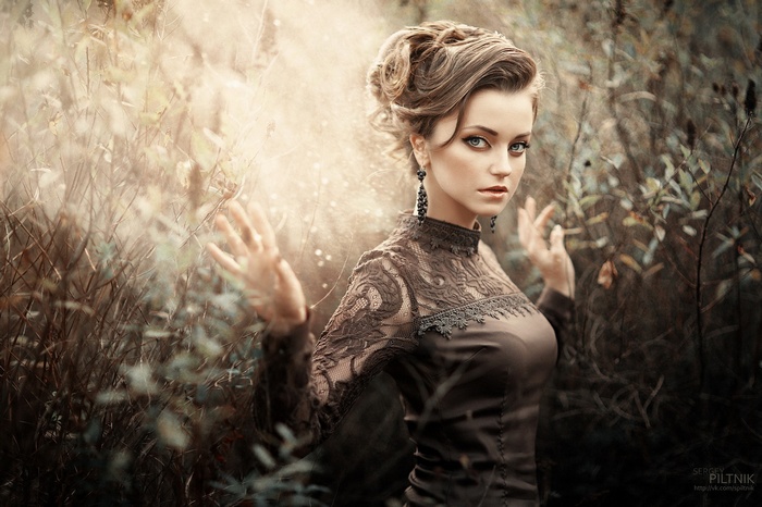 Model with blue eyes in a vintage dress outdoors