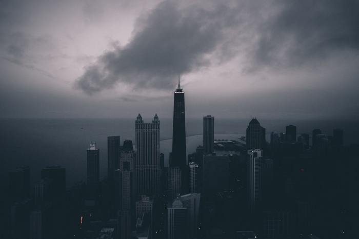 Cityscape with tall buildings under cloudy sky
