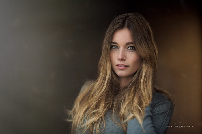 Portrait of a blonde woman with freckles by Manthos Tsakiridis