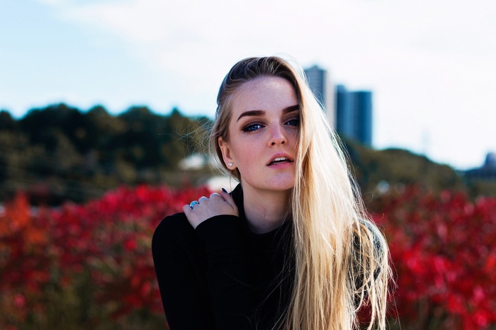 Woman with blonde hair and blue eyes outdoors