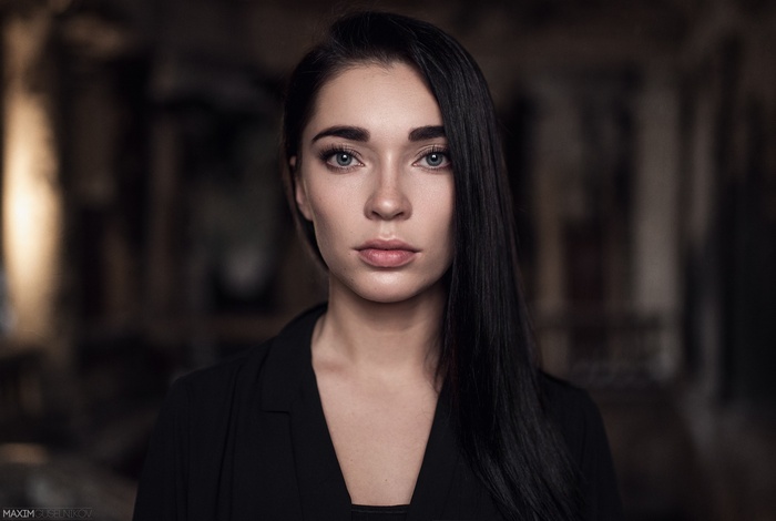Portrait of a woman with dark hair and blue eyes