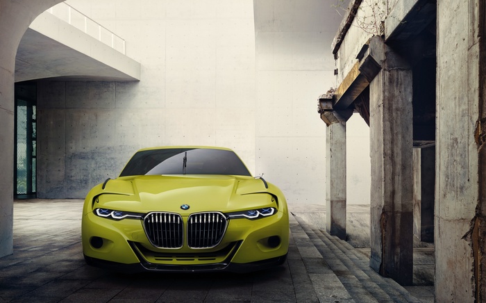 Yellow BMW concept car parked in urban setting