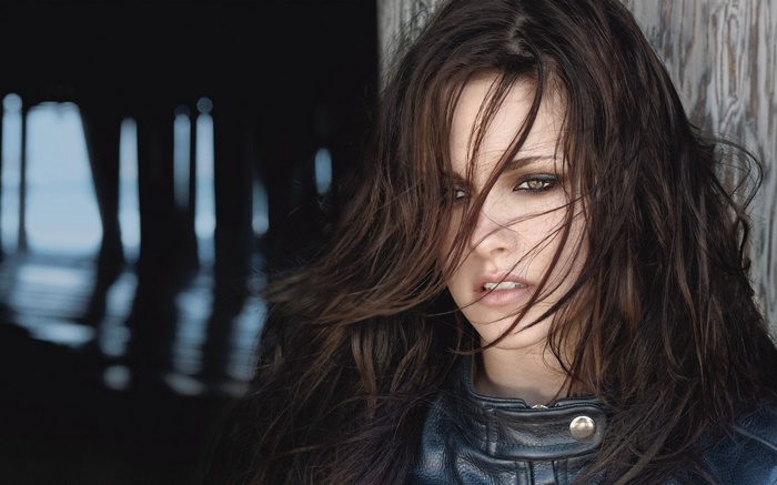 Kristen Stewart with hair in face wearing leather jacket