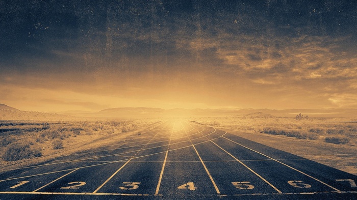 Running track in a desert landscape at sunset