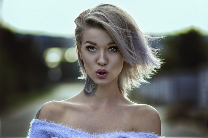 Woman with blonde short hair and tattoos